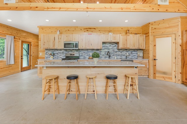 20470 220th St, Verndale, MN 56481 - kitchen featuring appliances with stainless steel finishes, concrete flooring, recessed lighting, a breakfast bar area, and a kitchen island
