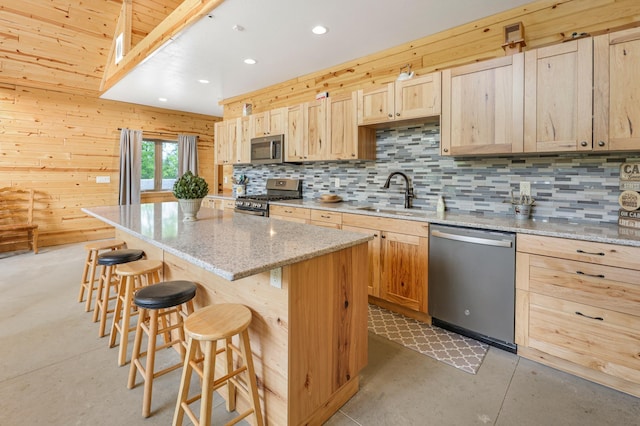 20470 220th St, Verndale, MN 56481 - kitchen with appliances with stainless steel finishes, a sink, light brown cabinets, concrete flooring, and a center island
