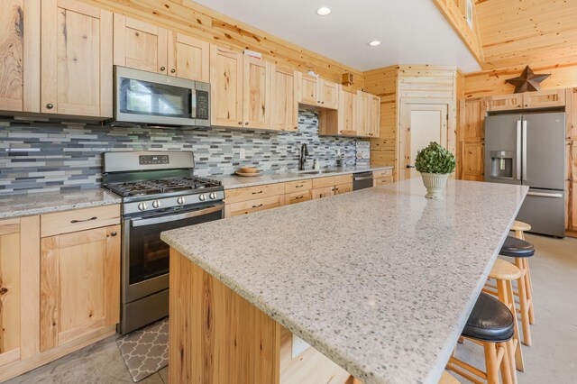 20470 220th St, Verndale, MN 56481 - kitchen with stainless steel appliances, light brown cabinets, a sink, a kitchen breakfast bar, and a center island