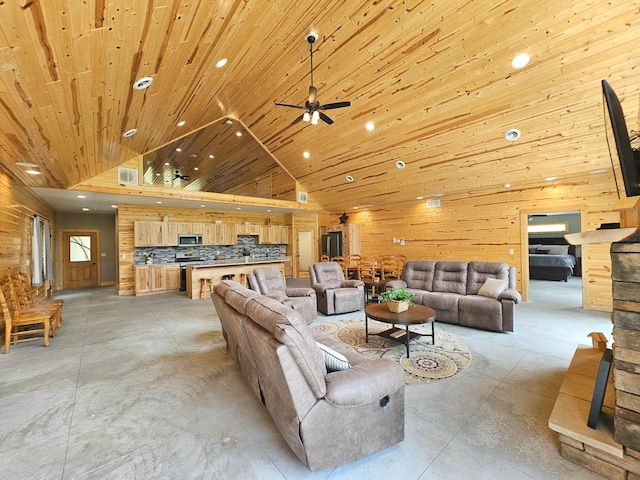 20470 220th St, Verndale, MN 56481 - living room with concrete flooring, wood walls, a ceiling fan, high vaulted ceiling, and recessed lighting