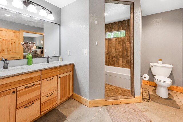 20470 220th St, Verndale, MN 56481 - bathroom featuring double vanity, baseboards, toilet, washtub / shower combination, and tile patterned flooring