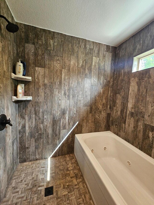 20470 220th St, Verndale, MN 56481 - bathroom with a tub with jets, a textured ceiling, and a tile shower