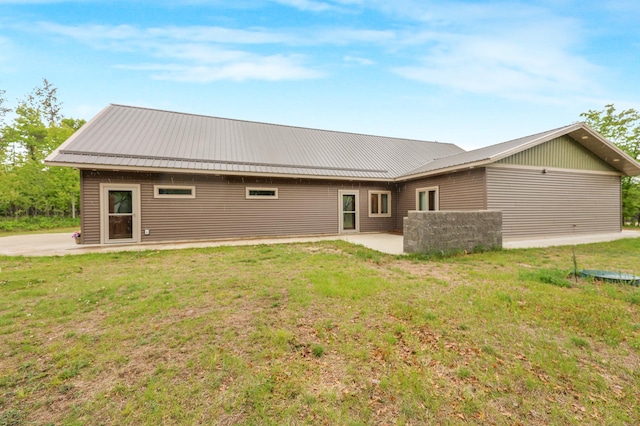 20470 220th St, Verndale, MN 56481 - back of house with a patio area, metal roof, and a lawn