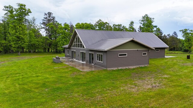 20470 220th St, Verndale, MN 56481 - view of side of home with a patio, a lawn, and metal roof