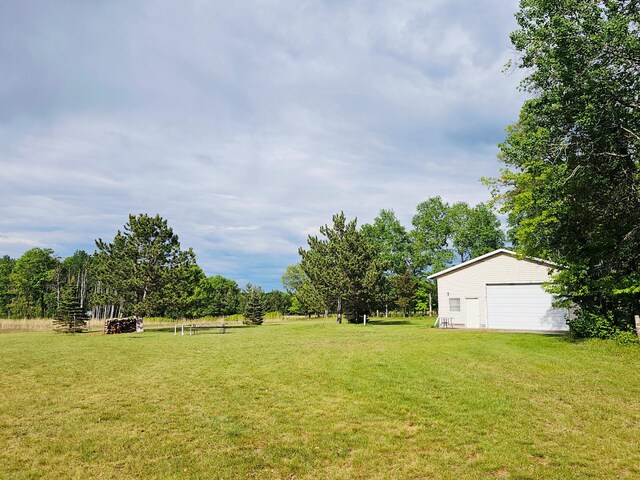 20470 220th St, Verndale, MN 56481 - view of green lawn with an outbuilding and a garage