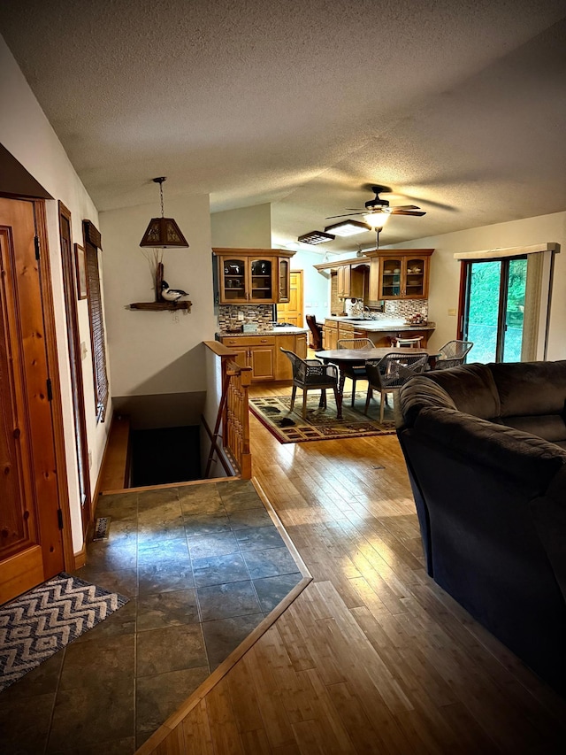 33688 416th Ave, Farm Island Twp, MN 56431 - living area featuring a textured ceiling, lofted ceiling, a ceiling fan, and dark wood-type flooring