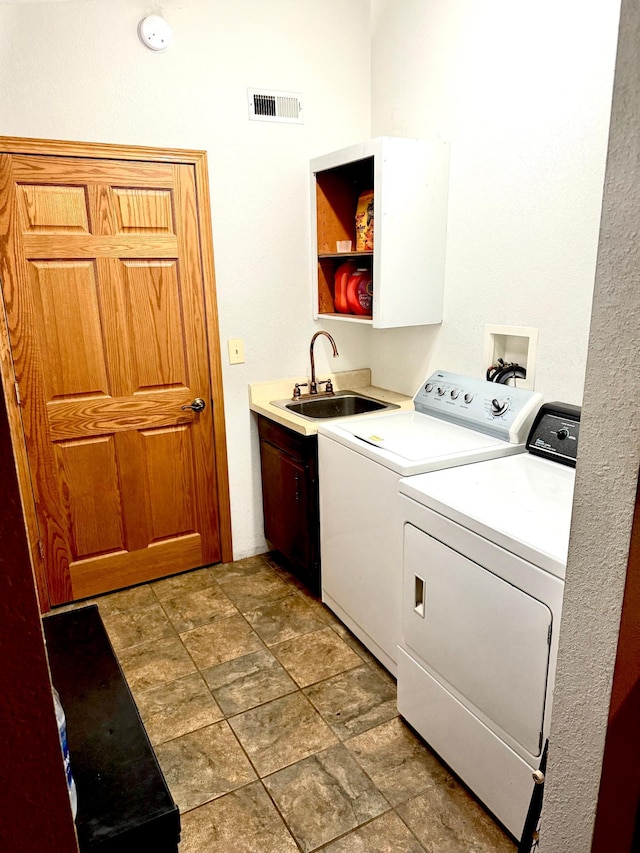 33688 416th Ave, Farm Island Twp, MN 56431 - laundry room with washing machine and clothes dryer, cabinet space, and light stone finish floors