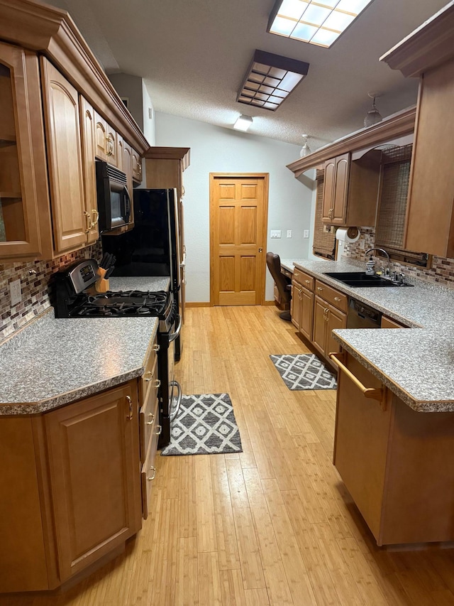 33688 416th Ave, Farm Island Twp, MN 56431 - kitchen with black microwave, gas stove, a sink, and backsplash