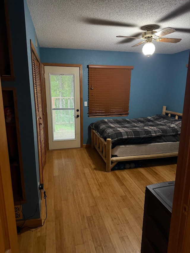 33688 416th Ave, Farm Island Twp, MN 56431 - bedroom featuring light wood-style floors, a textured ceiling, and ceiling fan