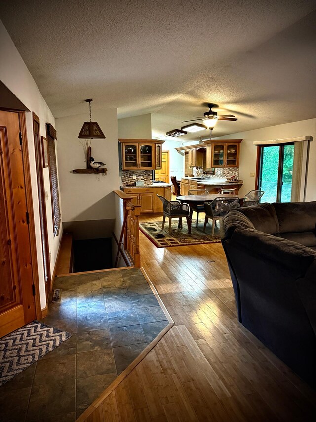 33688 416th Ave, Farm Island Twp, MN 56431 - living area featuring a textured ceiling, dark wood finished floors, ceiling fan, and lofted ceiling