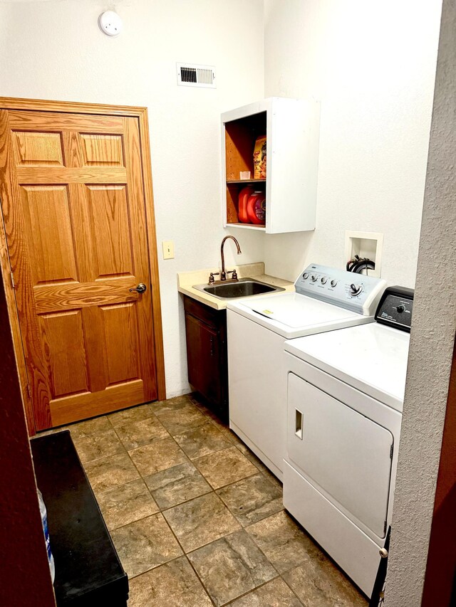 33688 416th Ave, Farm Island Twp, MN 56431 - laundry area featuring independent washer and dryer, cabinet space, and light stone finish floors
