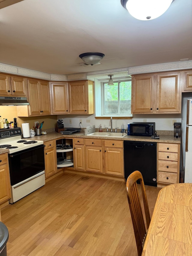 33688 416th Ave, Farm Island Twp, MN 56431 - kitchen with black appliances, a sink, light wood-style floors, light countertops, and under cabinet range hood