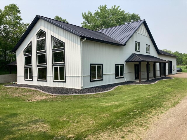 51509 County Highway 9, Scambler Twp, MN 56572 - view of property exterior featuring a lawn, metal roof, and a standing seam roof