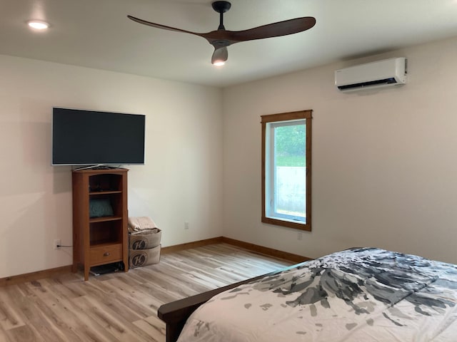 51509 County Highway 9, Scambler Twp, MN 56572 - bedroom with a wall unit AC, light wood finished floors, baseboards, and ceiling fan