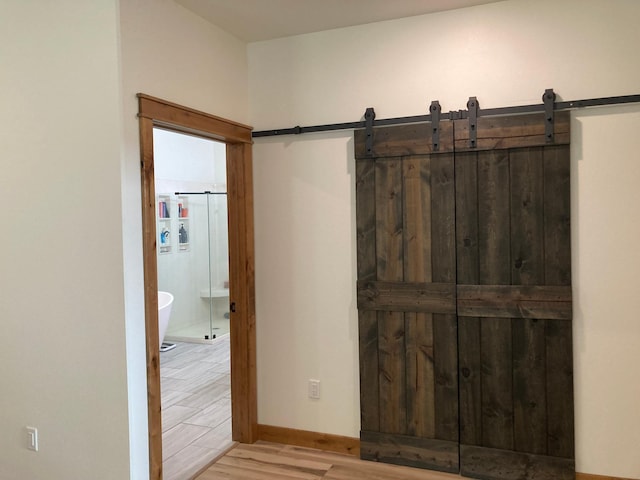 51509 County Highway 9, Scambler Twp, MN 56572 - hall with light wood finished floors, baseboards, and a barn door