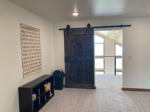 51509 County Highway 9, Scambler Twp, MN 56572 - unfurnished living room with carpet flooring, baseboards, and a barn door