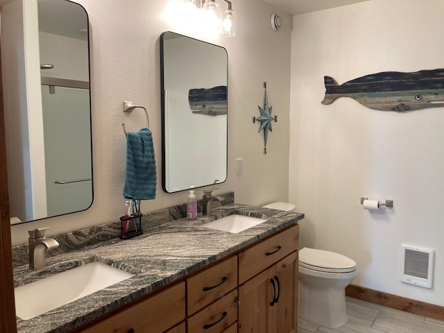51509 County Highway 9, Scambler Twp, MN 56572 - full bath featuring heating unit, toilet, double vanity, and baseboards