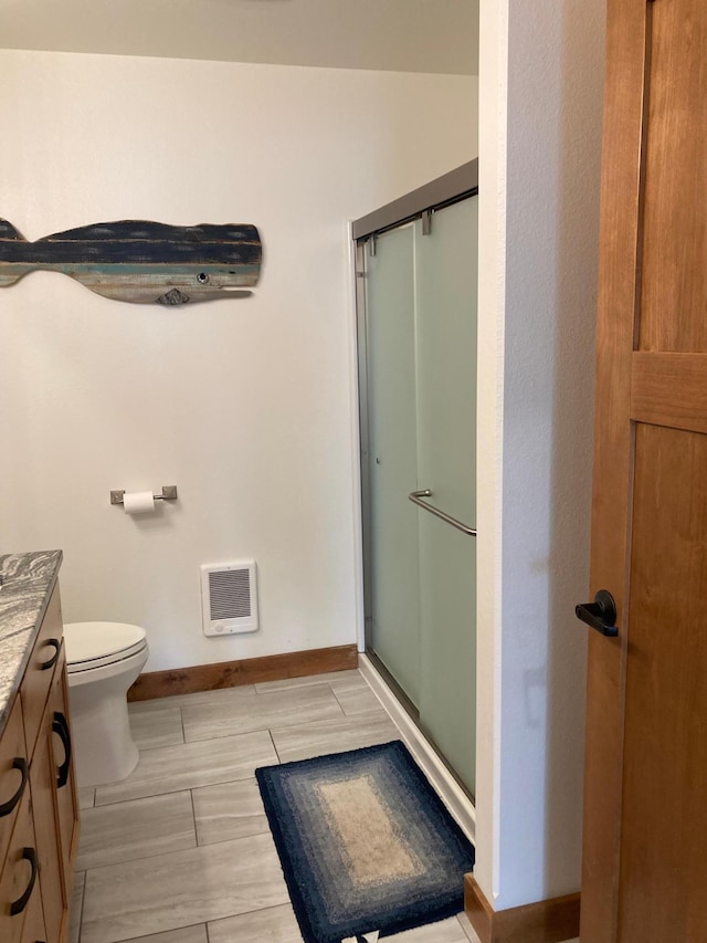 51509 County Highway 9, Scambler Twp, MN 56572 - bathroom with baseboards, vanity, a shower stall, heating unit, and toilet