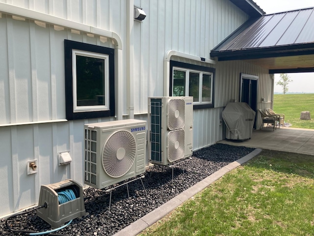 51509 County Highway 9, Scambler Twp, MN 56572 - view of side of home with a cooling unit, board and batten siding, metal roof, and a patio