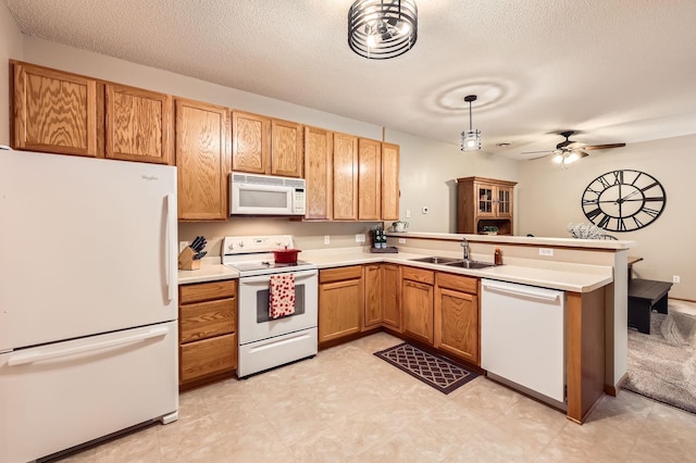 17673 96th Ave N, Maple Grove, MN 55311 - kitchen featuring white appliances, a sink, a peninsula, light countertops, and a textured ceiling