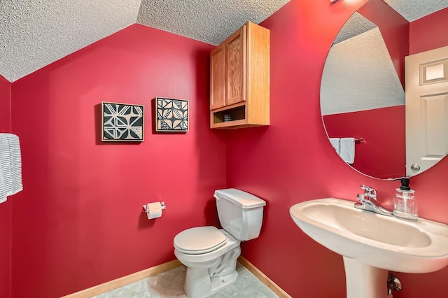 17673 96th Ave N, Maple Grove, MN 55311 - half bath featuring a textured ceiling, toilet, lofted ceiling, baseboards, and a sink