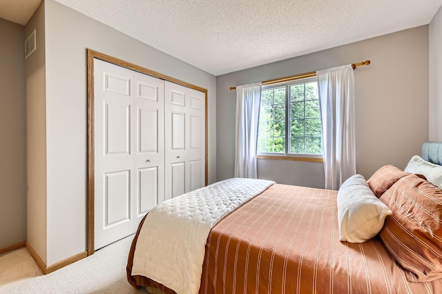17673 96th Ave N, Maple Grove, MN 55311 - bedroom featuring carpet, a closet, baseboards, and a textured ceiling