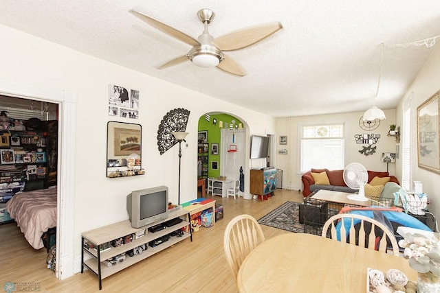 108 6th Ave N, Fargo, ND 58102 - dining room featuring wood finished floors, ceiling fan, arched walkways, and a textured ceiling