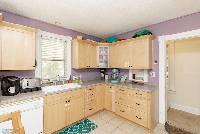 108 6th Ave N, Fargo, ND 58102 - kitchen with light brown cabinetry, a sink, dishwasher, and a textured ceiling