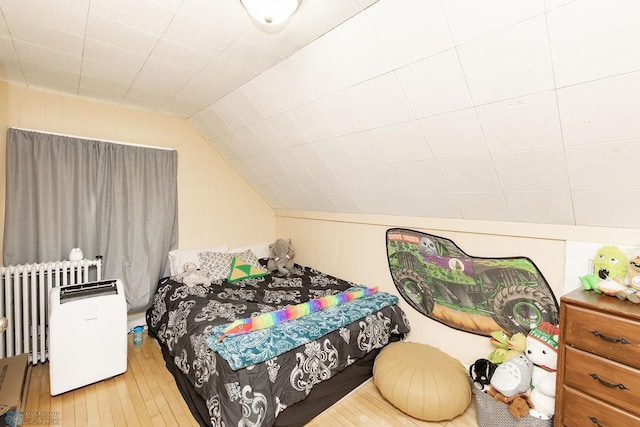 108 6th Ave N, Fargo, ND 58102 - bedroom featuring radiator, wood-type flooring, and lofted ceiling