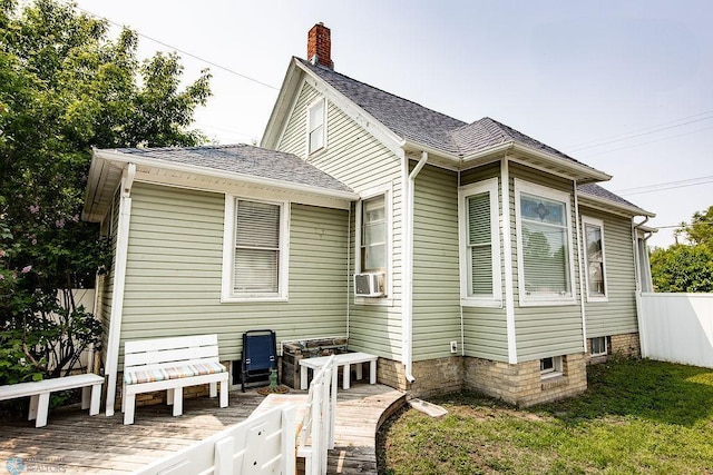 108 6th Ave N, Fargo, ND 58102 - back of property with a deck, a chimney, cooling unit, and roof with shingles