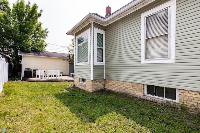 108 6th Ave N, Fargo, ND 58102 - view of side of property with a lawn and a chimney