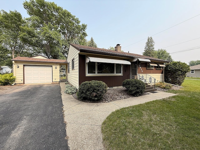 1620 4th St, Montevideo, MN 56265 - view of front of home with a chimney, a front lawn, and driveway