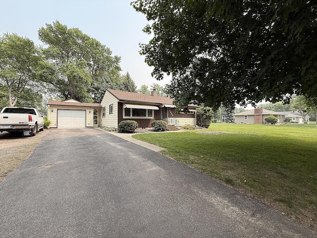 1620 4th St, Montevideo, MN 56265 - ranch-style home with a chimney, a front yard, asphalt driveway, and a garage