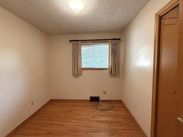 1620 4th St, Montevideo, MN 56265 - unfurnished room featuring light wood finished floors, a textured ceiling, and baseboards