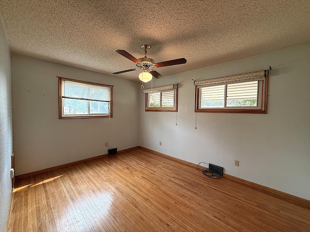 1620 4th St, Montevideo, MN 56265 - unfurnished room featuring ceiling fan, light wood finished floors, a textured ceiling, and baseboards