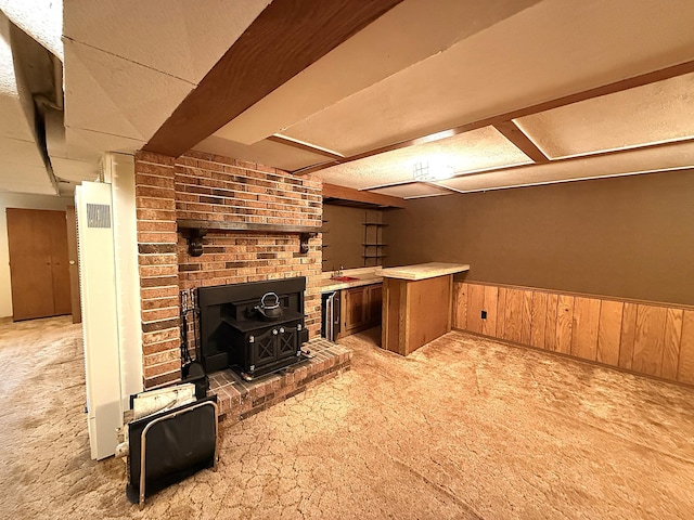 1620 4th St, Montevideo, MN 56265 - bar area featuring carpet flooring, a wood stove, wainscoting, and wooden walls