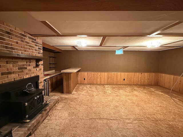 1620 4th St, Montevideo, MN 56265 - bar area featuring a wood stove, carpet floors, wood walls, and a wainscoted wall