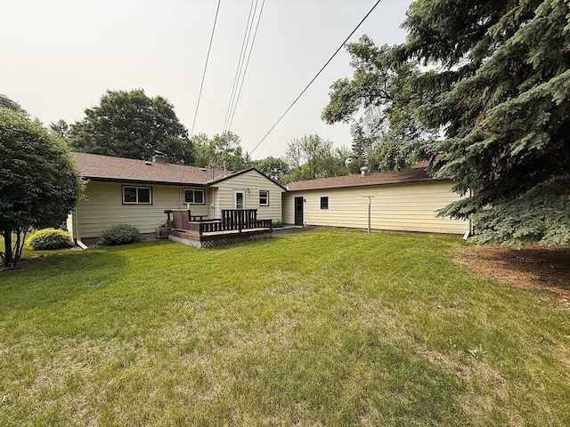 1620 4th St, Montevideo, MN 56265 - back of property with a wooden deck and a lawn