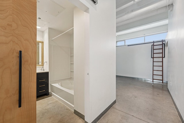 700 Washington Ave N Unit 601, Minneapolis, MN 55401 - full bath featuring vanity, washtub / shower combination, a towel warming rack, and concrete floors