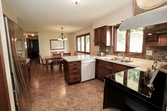 2805 12th Ave NW, Willmar, MN 56201 - kitchen with white dishwasher, a sink, a peninsula, under cabinet range hood, and decorative backsplash