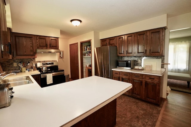 2805 12th Ave NW, Willmar, MN 56201 - kitchen featuring appliances with stainless steel finishes, a sink, under cabinet range hood, light countertops, and tasteful backsplash