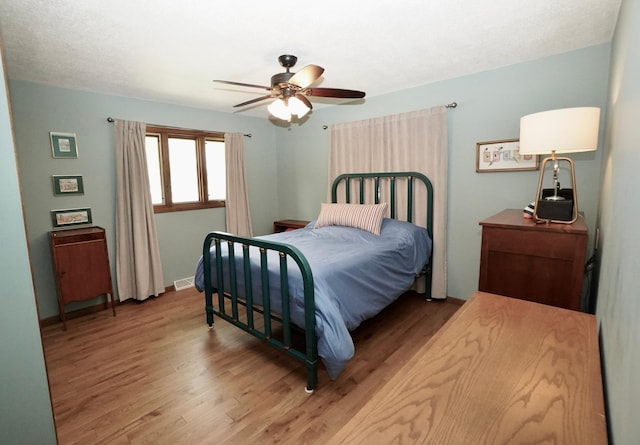 2805 12th Ave NW, Willmar, MN 56201 - bedroom featuring wood finished floors, ceiling fan, and baseboards