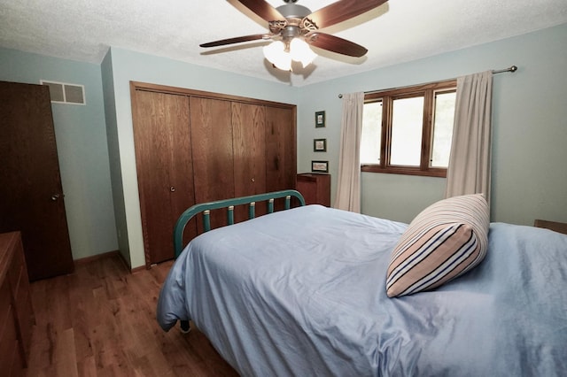 2805 12th Ave NW, Willmar, MN 56201 - bedroom featuring a closet, wood finished floors, and a ceiling fan