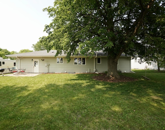 2805 12th Ave NW, Willmar, MN 56201 - rear view of house with a lawn and a patio area