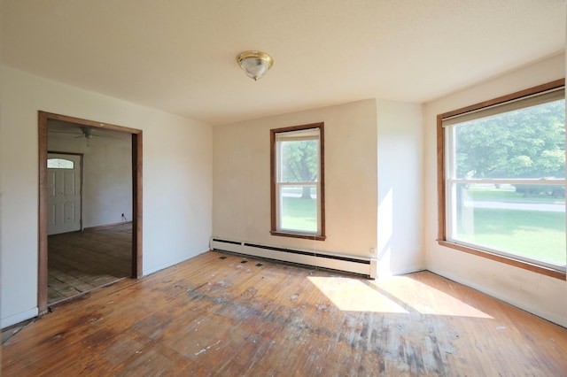 5741 Maple St, Rockford, MN 55373 - spare room featuring a baseboard heating unit, hardwood / wood-style floors, and ceiling fan