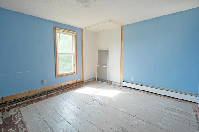 5741 Maple St, Rockford, MN 55373 - spare room featuring baseboard heating and a textured ceiling