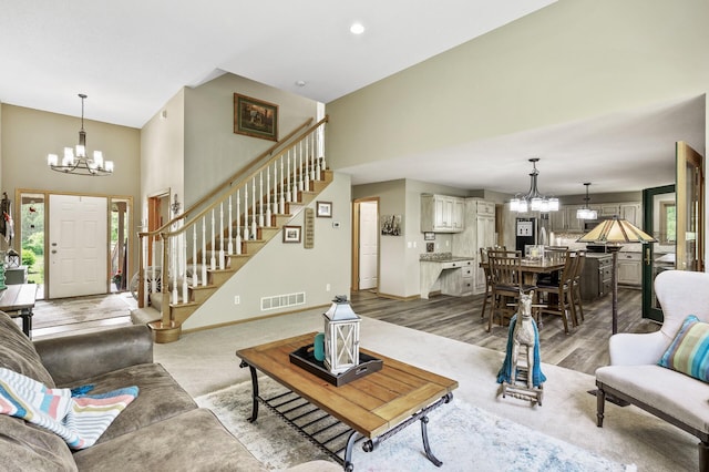 22774 Olivine St NW, Nowthen, MN 55330 - living area with a chandelier, a high ceiling, stairway, baseboards, and wood finished floors