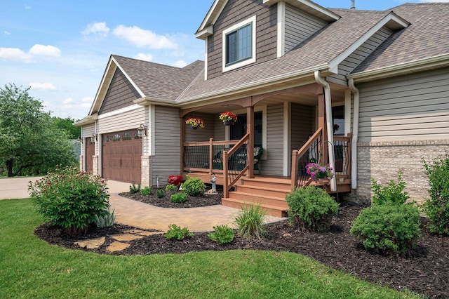 22774 Olivine St NW, Nowthen, MN 55330 - view of front of home featuring covered porch, a shingled roof, an attached garage, a front lawn, and driveway