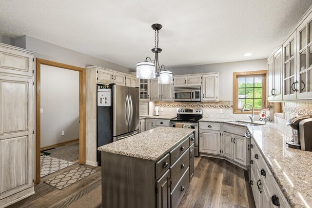 22774 Olivine St NW, Nowthen, MN 55330 - kitchen featuring appliances with stainless steel finishes, dark wood finished floors, a sink, backsplash, and recessed lighting