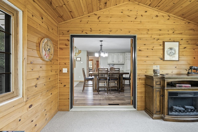 22774 Olivine St NW, Nowthen, MN 55330 - dining space featuring vaulted ceiling, wooden walls, a chandelier, carpet, and wood ceiling